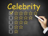 hand writing celebrity on black chalkboard