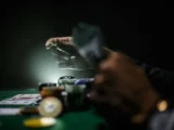 A man playing poker with poker chips and cards